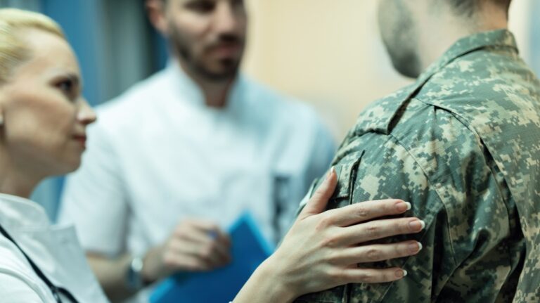 Doctor with hand on soldier's shoulder