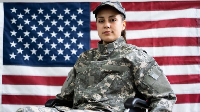 Army Veteran in a Wheelchair in Front of American Flag