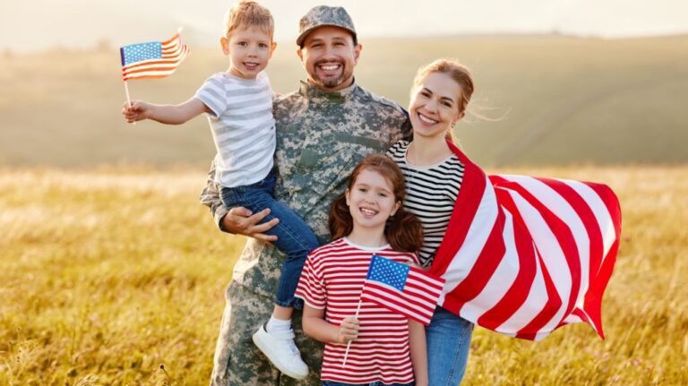 Soldier with His Family and American Flags in a Field