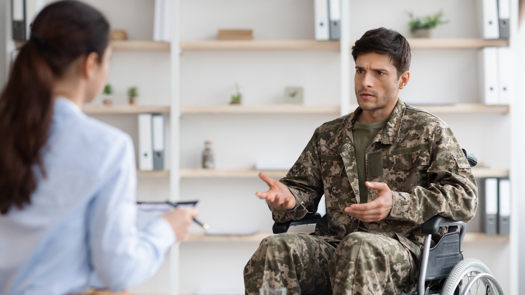 veteran in wheelchair speeking with lawyer