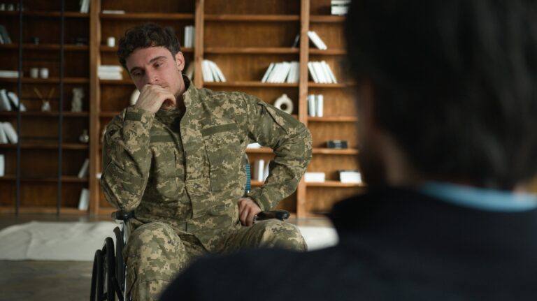 veteran in wheelchair talks to lawyer