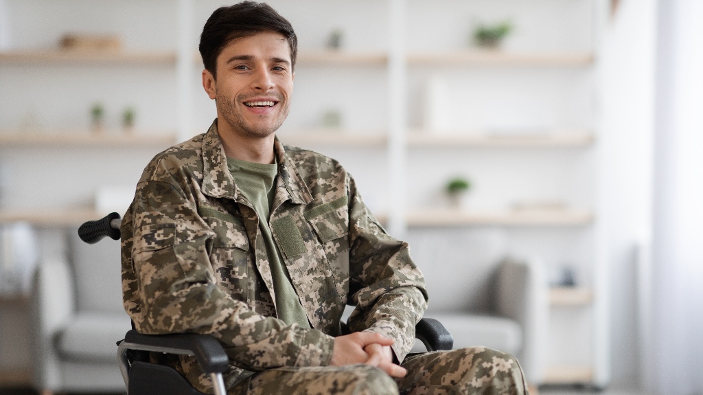 young man in camouflage uniform soldier sitting in wheelchair