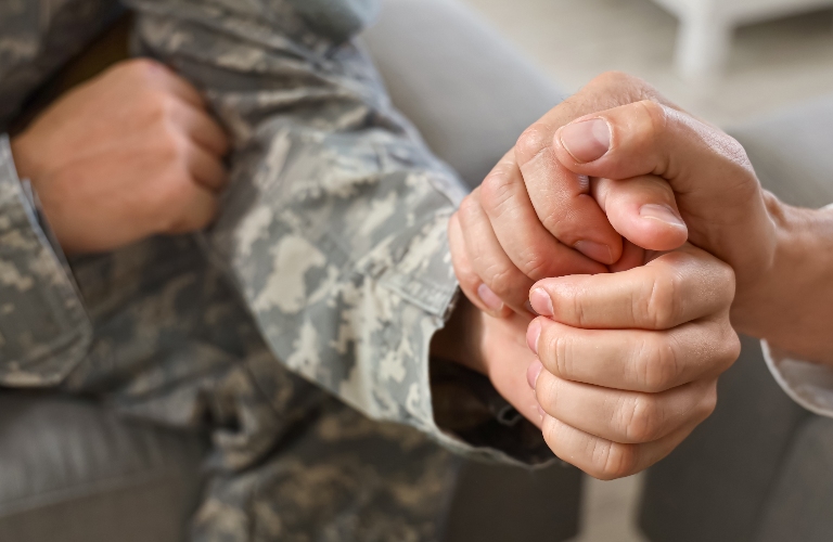 Psychologist calming soldier during psychotherapy session