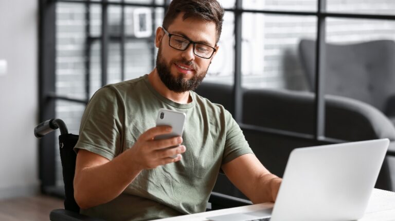 Soldier in wheelchair using mobile phone