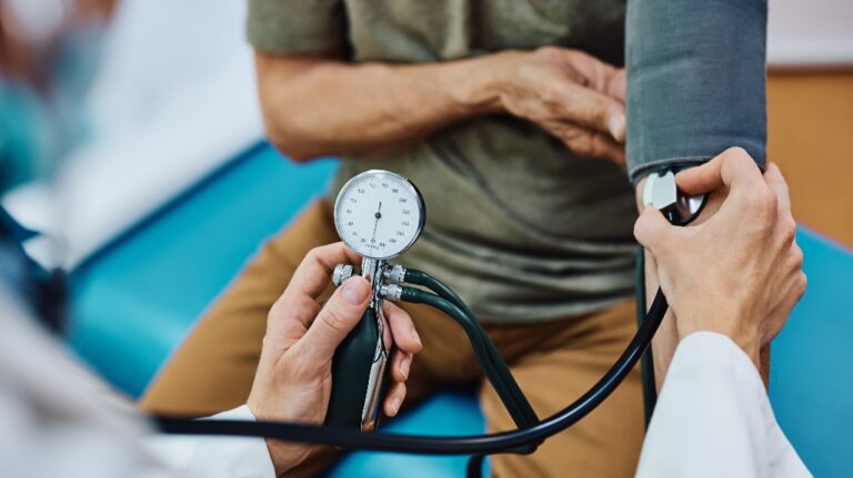 man getting his blood pressure checked during medical examination