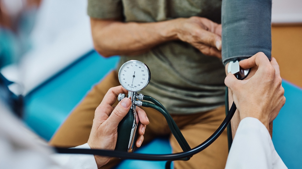 man getting his blood pressure checked during medical examination