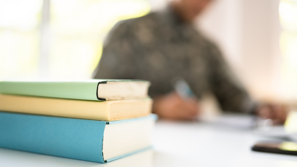Military Student Education. Army Soldier Veteran With Books