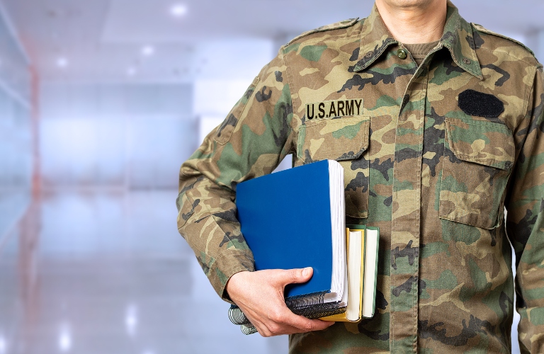 Soldier with books in hand and ready to go back to the academy as a student and copy space